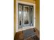 Close-up of front door featuring glass panes and detailed trim at 4222 Glade Wood Loop, New Port Richey, FL 34655