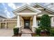 View of the front entrance with a decorative door, stone accents, and well-manicured greenery at 4222 Glade Wood Loop, New Port Richey, FL 34655