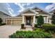 Charming single Gathering house featuring manicured front yard and stone details on the columns at 4222 Glade Wood Loop, New Port Richey, FL 34655