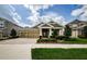 Charming exterior view with a well manicured lawn, a two car garage and neutral tones at 4222 Glade Wood Loop, New Port Richey, FL 34655