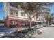 Charming building with striped awnings, outdoor patio seating, and street parking. Lush foliage at 4222 Glade Wood Loop, New Port Richey, FL 34655