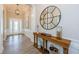 Elegant foyer with wood flooring, console table, and modern decorative mirror at 4222 Glade Wood Loop, New Port Richey, FL 34655