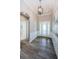 Entryway featuring wood floors, decorative wall paneling and an arched doorway at 4222 Glade Wood Loop, New Port Richey, FL 34655