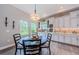 Bright kitchen features wood cabinets, a breakfast table, and multiple windows for natural light at 4222 Glade Wood Loop, New Port Richey, FL 34655