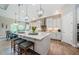 A modern kitchen with stainless appliances, a large island with seating, and custom cabinets at 4222 Glade Wood Loop, New Port Richey, FL 34655