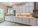 Beautiful kitchen with custom cabinetry, backsplash, counter lighting, stainless appliances, and wood flooring at 4222 Glade Wood Loop, New Port Richey, FL 34655