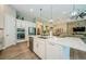Gourmet kitchen with double ovens, stainless steel appliances and a center island overlooking the living space at 4222 Glade Wood Loop, New Port Richey, FL 34655