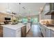 Open-concept kitchen boasts a large center island, stainless appliances, and seamless flow to the living area at 4222 Glade Wood Loop, New Port Richey, FL 34655