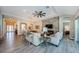 Bright living room features modern decor, a stone accent wall, and wood-look tile flooring at 4222 Glade Wood Loop, New Port Richey, FL 34655