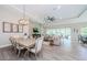 Open-concept living space with access to the lanai, dining area, and kitchen at 4222 Glade Wood Loop, New Port Richey, FL 34655