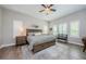 Spacious main bedroom with wood floors, tray ceilings, large windows, and tasteful decor at 4222 Glade Wood Loop, New Port Richey, FL 34655