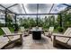 Outdoor patio featuring stone flooring, comfortable chairs, and a relaxing fire pit at 4222 Glade Wood Loop, New Port Richey, FL 34655