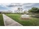A lush green Owney Park includes green grass, a sidewalk, and manicured trees at 4222 Glade Wood Loop, New Port Richey, FL 34655
