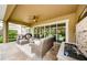 Relaxing outdoor patio with comfortable seating, a ceiling fan, and tranquil water feature at 4222 Glade Wood Loop, New Port Richey, FL 34655