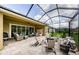 Large covered patio with outdoor seating, water feature, and fire pit at 4222 Glade Wood Loop, New Port Richey, FL 34655