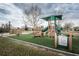 Community playground with swings, slides, and a playhouse, perfect for recreation and outdoor fun at 4222 Glade Wood Loop, New Port Richey, FL 34655
