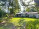 Exterior view of home with a screened porch and greenery at 4404 Hickory Branch Ct, Brandon, FL 33511