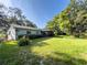 Lush backyard with a screened porch, and mature trees providing shade at 4404 Hickory Branch Ct, Brandon, FL 33511