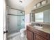 Bright bathroom with a glass-enclosed shower, granite countertop, and modern fixtures at 4404 Hickory Branch Ct, Brandon, FL 33511