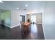 Inviting dining room featuring sleek wood floors, a modern chandelier, and an abundance of natural light at 4404 Hickory Branch Ct, Brandon, FL 33511