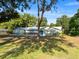 Charming home featuring stone details, a well-kept lawn, and mature shade trees at 4404 Hickory Branch Ct, Brandon, FL 33511