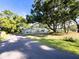 Spacious property with mature trees, stone accents, and long driveway at 4404 Hickory Branch Ct, Brandon, FL 33511