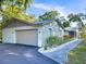 View of the garage and side of home, including landscaping and stone details at 4404 Hickory Branch Ct, Brandon, FL 33511