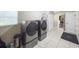 Well-organized laundry room equipped with modern washer and dryer, convenient storage, and a tiled floor at 4404 Hickory Branch Ct, Brandon, FL 33511