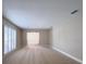 Bright living room featuring neutral carpet, shuttered windows, and a smooth transition into the rest of the home at 4404 Hickory Branch Ct, Brandon, FL 33511