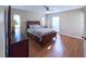Spacious main bedroom featuring wood floors, ample natural light, and comfortable furnishings at 4404 Hickory Branch Ct, Brandon, FL 33511