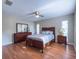 Well-lit main bedroom showcasing wood flooring and a comfortable bed with a ceiling fan at 4404 Hickory Branch Ct, Brandon, FL 33511