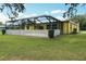 Beautiful home exterior featuring a white fence and screened in patio at 4407 Westwood Dr, Holiday, FL 34691