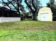 Large backyard featuring a tool shed and screened in patio at 4407 Westwood Dr, Holiday, FL 34691