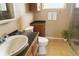 Cozy bathroom with a shower, sink, vanity, and ceramic floors at 4407 Westwood Dr, Holiday, FL 34691