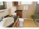 Cozy bathroom with a shower, sink, vanity, and ceramic floors at 4407 Westwood Dr, Holiday, FL 34691