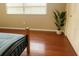 Bedroom showcasing hardwood floors, a large window, and closet with panel doors at 4407 Westwood Dr, Holiday, FL 34691