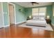 Bright bedroom with a large window, ceiling fan, and light gray rug at 4407 Westwood Dr, Holiday, FL 34691