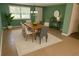Bright dining room with green walls, table with six chairs, and a plant in the corner at 4407 Westwood Dr, Holiday, FL 34691