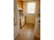 Cozy kitchen features a white refrigerator, light countertops and wood cabinets at 4407 Westwood Dr, Holiday, FL 34691