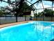 A screened-in pool is filled with clear blue water, with a shed in the back yard at 4407 Westwood Dr, Holiday, FL 34691