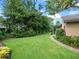 Spacious backyard featuring a green lawn and mature landscaping at 4610 Westford Cir, Tampa, FL 33618