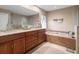 Spacious bathroom with granite countertops, tile flooring, and a built-in soaking tub at 4610 Westford Cir, Tampa, FL 33618