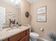 This bathroom features a granite countertop and decorative wall art, providing an elegant and functional space at 4610 Westford Cir, Tampa, FL 33618
