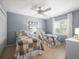 Shared bedroom with tile floors, bright blue walls, and a ceiling fan at 4610 Westford Cir, Tampa, FL 33618
