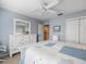Bedroom features tile floors, blue walls, a closet and a ceiling fan at 4610 Westford Cir, Tampa, FL 33618