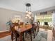 Dining room featuring a large table, decorative lighting, and an outdoor view at 4610 Westford Cir, Tampa, FL 33618