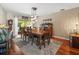 Dining room features a large wooden table, chandelier lighting, and view of the outdoor patio at 4610 Westford Cir, Tampa, FL 33618