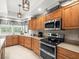 Traditional kitchen featuring stainless steel appliances, granite countertops, and custom wooden cabinetry at 4610 Westford Cir, Tampa, FL 33618