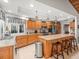 Open kitchen with custom cabinets, stainless steel appliances, and breakfast bar seating at 4610 Westford Cir, Tampa, FL 33618