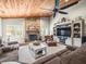 Cozy living room with stone fireplace, wood ceilings, and comfortable seating at 4610 Westford Cir, Tampa, FL 33618